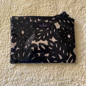 Black and cream cosmetic bag by Kate Spade.